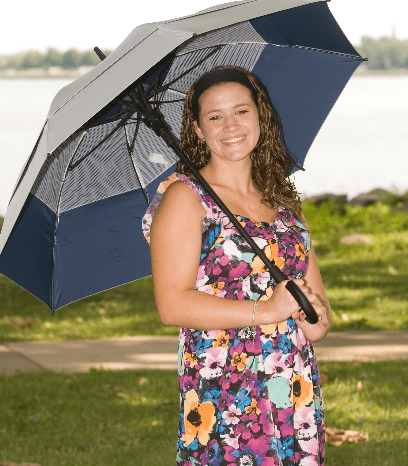 Woman holding a blue and grey umbrella.