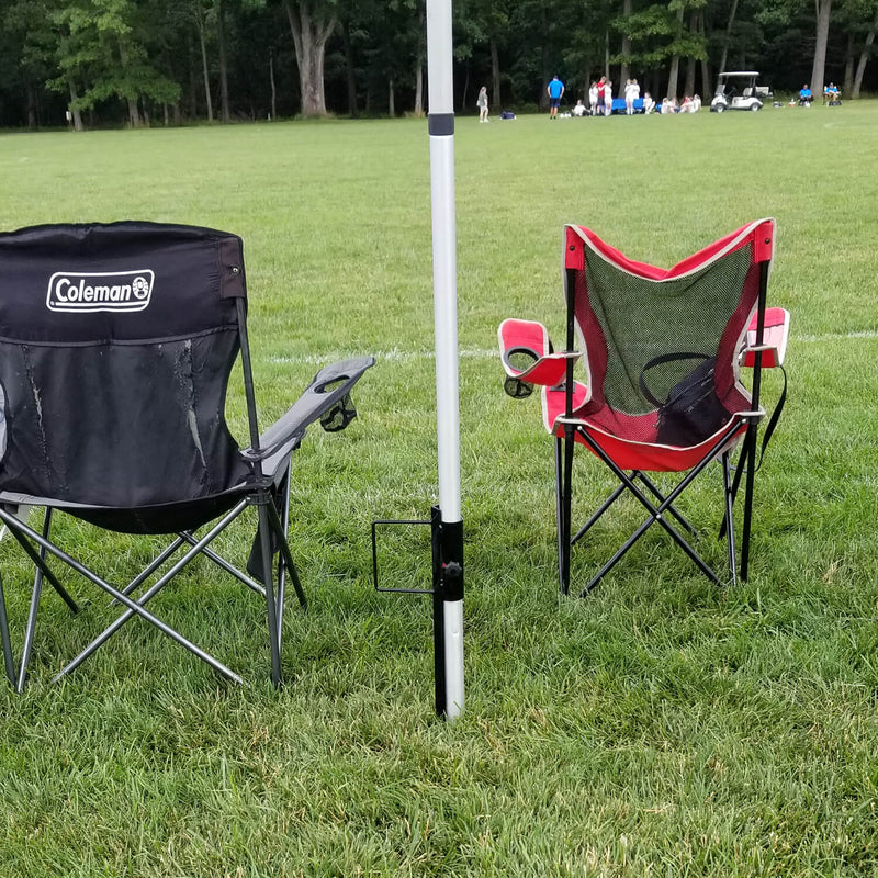 Folding chairs under umbrella at sports ground